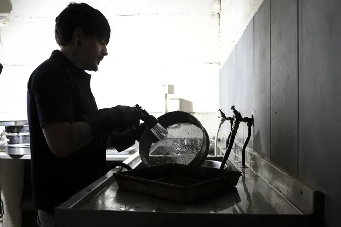 A Lab Technician washing a Soil Sample A Lab Technician washing a Soil Sample
